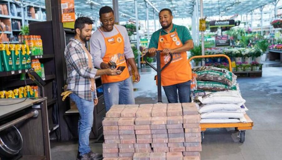 Home Depot associates helping a customer in the garden center