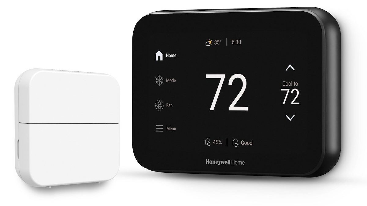 Honeywell Home smart thermostat showing 72 degrees next to a white room sensor